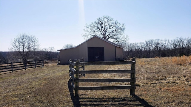 view of outbuilding featuring an exterior structure, a rural view, and an outdoor structure