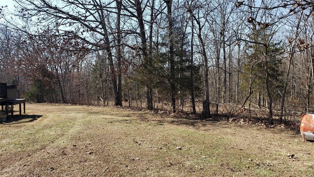 view of yard with a forest view