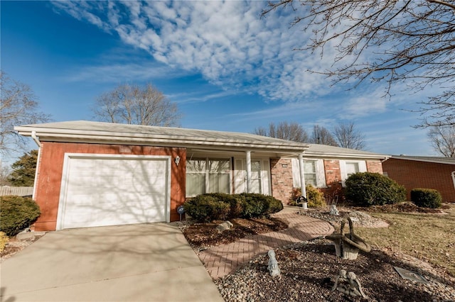 ranch-style home featuring concrete driveway and an attached garage