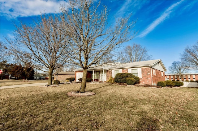 ranch-style home with a front yard and brick siding