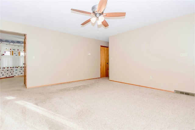 spare room with baseboards, visible vents, and carpet flooring