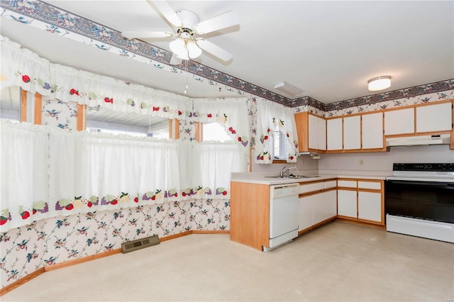 kitchen featuring under cabinet range hood, white appliances, a sink, visible vents, and light countertops