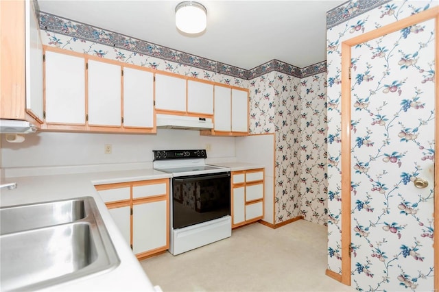 kitchen featuring under cabinet range hood, range with electric stovetop, a sink, light countertops, and wallpapered walls