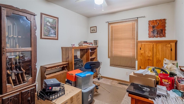 office space with carpet flooring, baseboards, and a ceiling fan