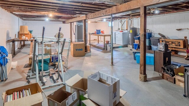 unfinished basement featuring washing machine and clothes dryer