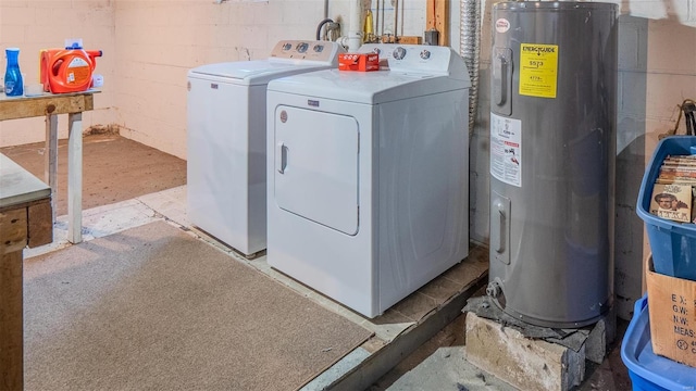 laundry room featuring washer and dryer, concrete block wall, and electric water heater