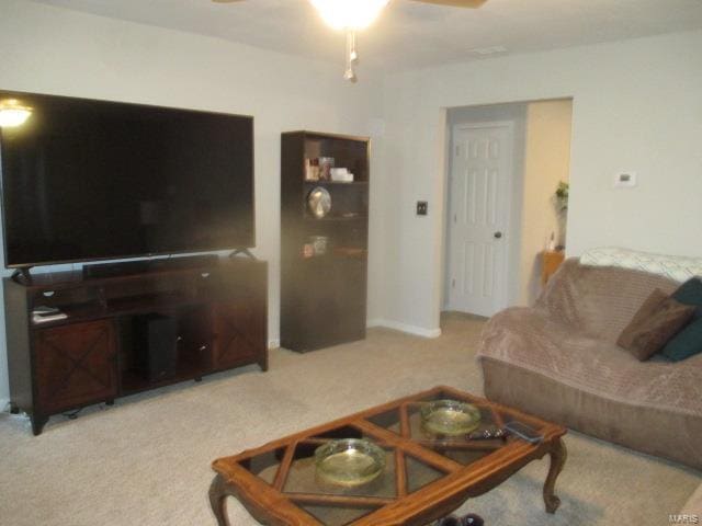 living room featuring carpet flooring and ceiling fan