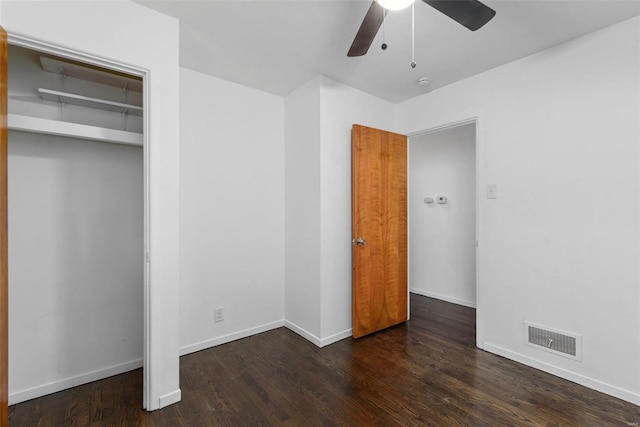 unfurnished bedroom featuring a closet, visible vents, ceiling fan, wood finished floors, and baseboards