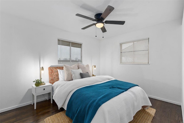 bedroom featuring a ceiling fan, baseboards, and wood finished floors