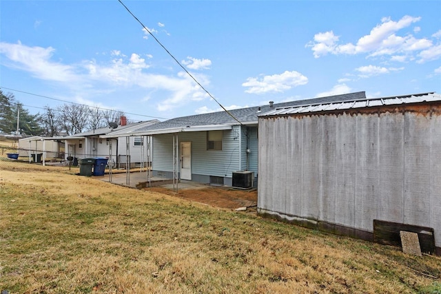 back of property with a patio and a yard