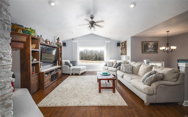 living room featuring baseboards, vaulted ceiling, dark wood-type flooring, and ceiling fan with notable chandelier