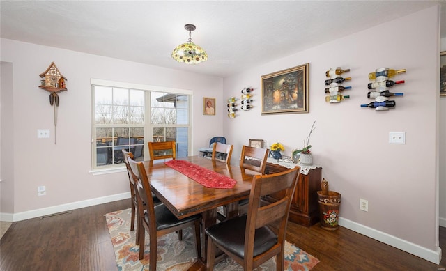 dining area with visible vents, baseboards, and wood finished floors