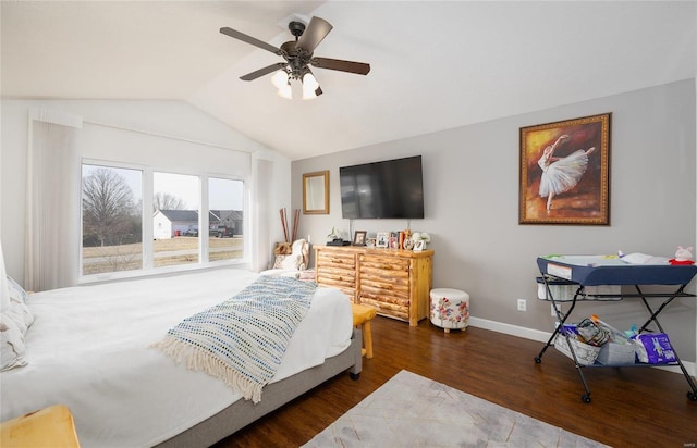 bedroom with a ceiling fan, baseboards, vaulted ceiling, and wood finished floors