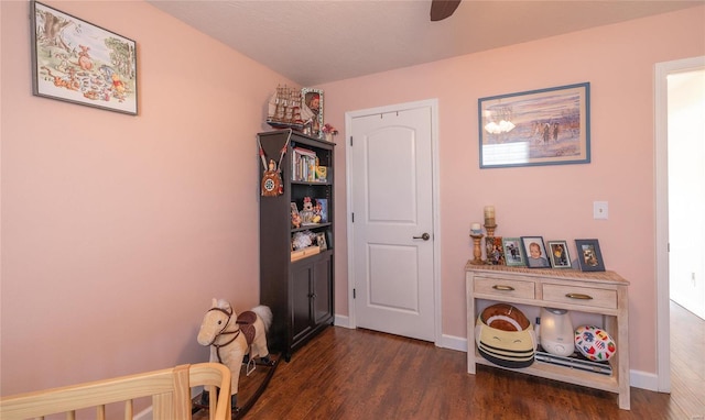 interior space with dark wood-style flooring and baseboards