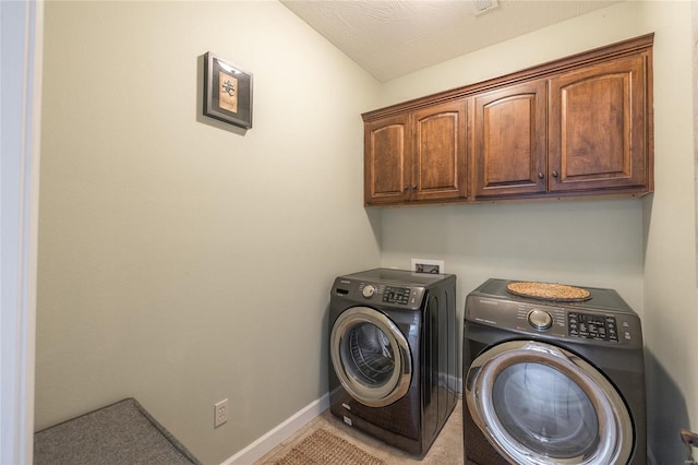 laundry area with cabinet space, washer and clothes dryer, and baseboards