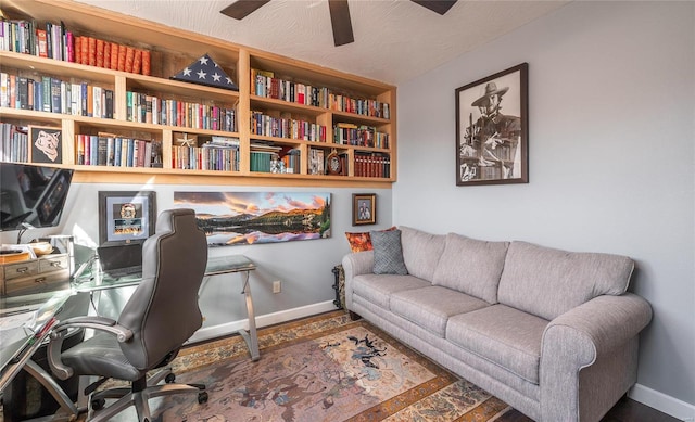 office space featuring wood finished floors, a ceiling fan, and baseboards