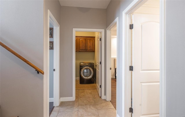 hall featuring washer / dryer and baseboards