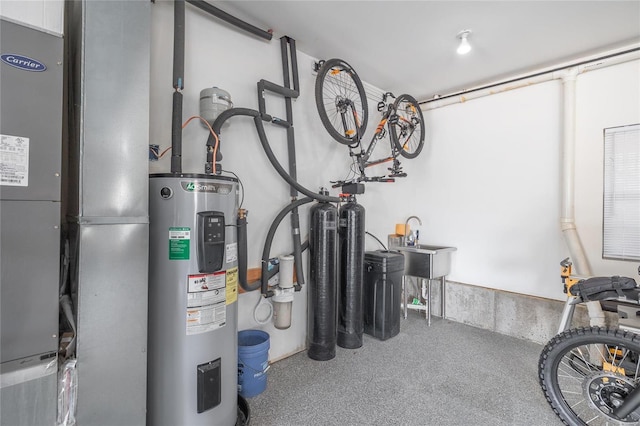 utility room with heating unit, a sink, and electric water heater