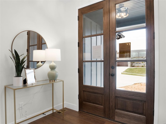 entryway featuring dark wood-type flooring, french doors, and baseboards