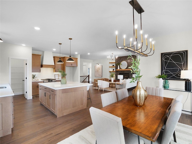 dining room with a fireplace, dark wood-style flooring, and recessed lighting