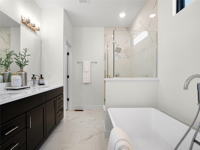 full bathroom with double vanity, marble finish floor, a freestanding tub, a walk in shower, and a sink