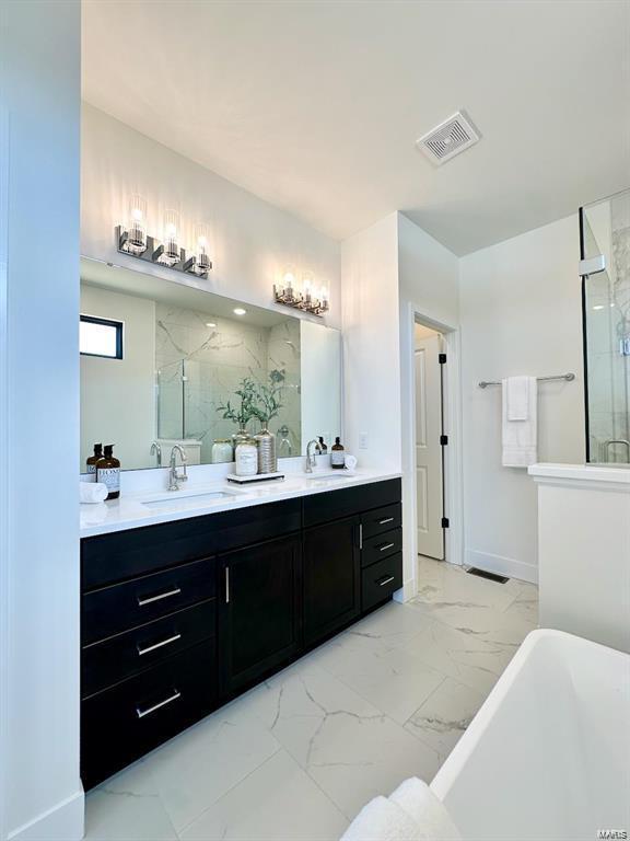 bathroom with double vanity, a marble finish shower, visible vents, marble finish floor, and a sink