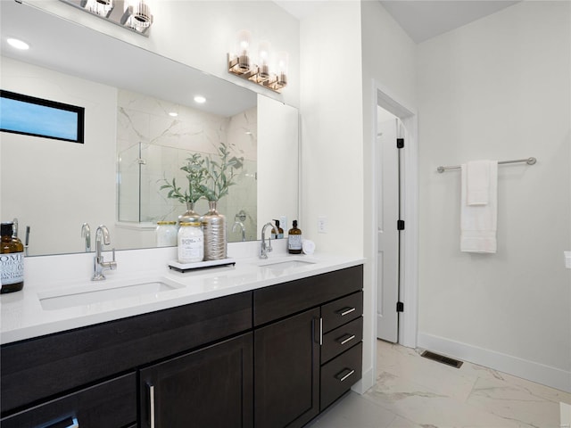full bath with marble finish floor, a marble finish shower, a sink, and visible vents