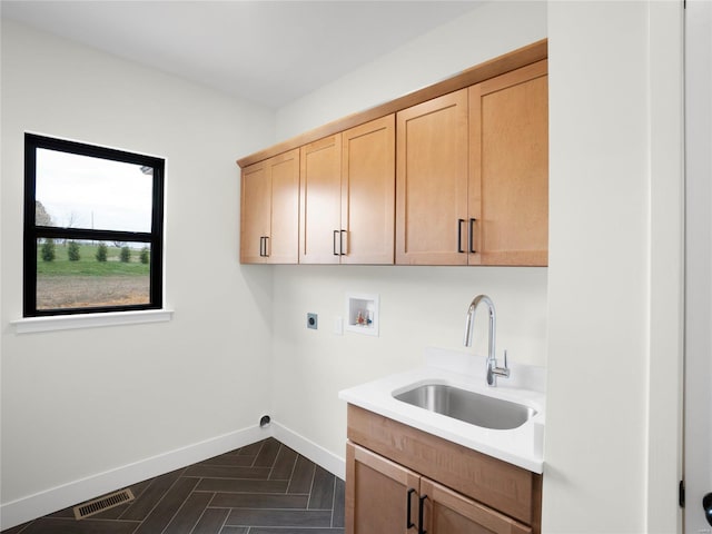 clothes washing area with hookup for a washing machine, cabinet space, visible vents, hookup for an electric dryer, and a sink