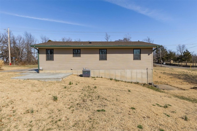 rear view of house with a patio area and central AC unit