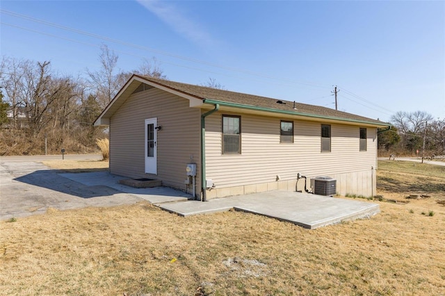 back of property with a patio area, a lawn, and cooling unit