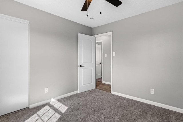 unfurnished room with ceiling fan, baseboards, and carpet flooring