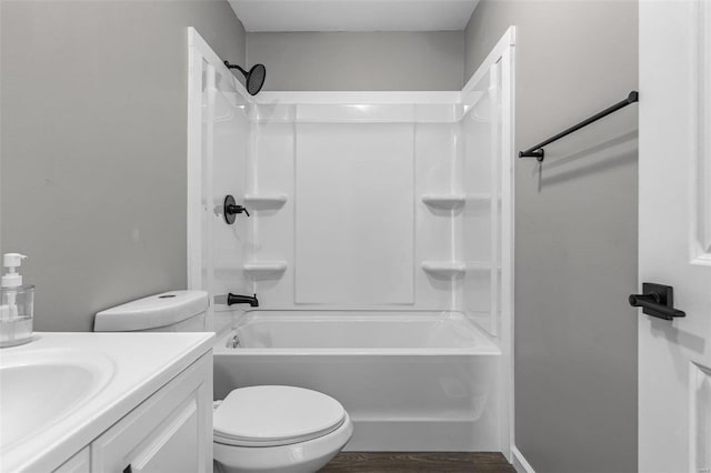 bathroom with shower / bathtub combination, vanity, wood finished floors, and toilet