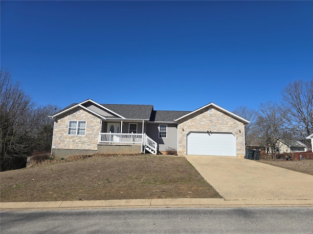 ranch-style house with stone siding, covered porch, concrete driveway, and a garage