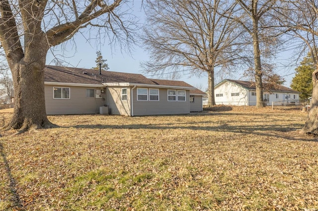 exterior space with a front yard, central AC, and fence