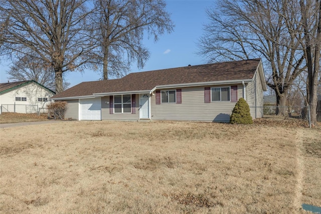 ranch-style house featuring driveway, fence, and a front yard