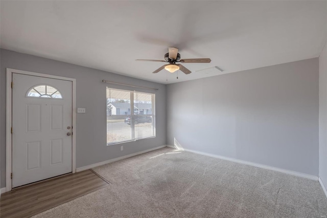 foyer with carpet floors, ceiling fan, and baseboards