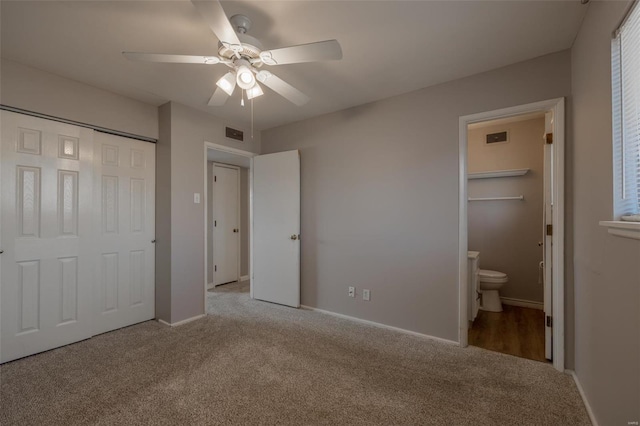 unfurnished bedroom with carpet, visible vents, baseboards, and ensuite bathroom