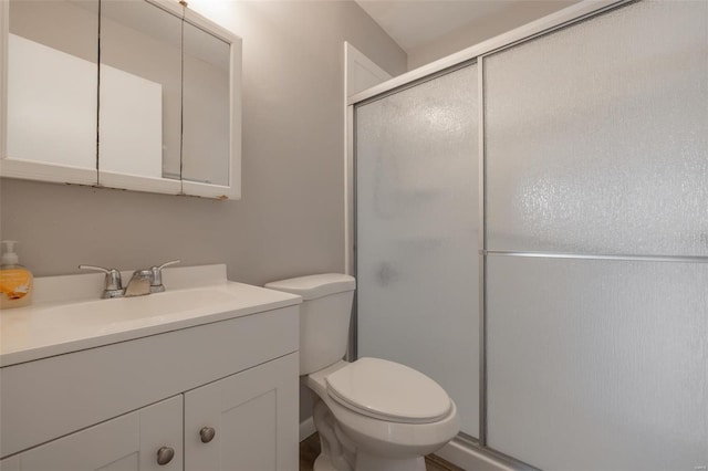 full bath featuring a shower stall, toilet, and vanity