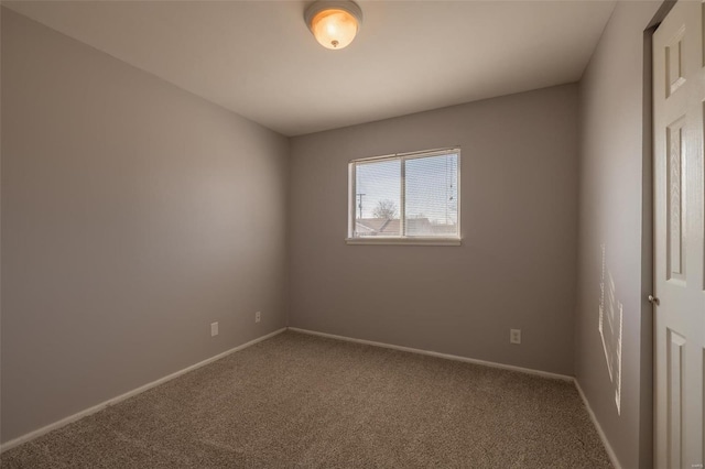 spare room with carpet and baseboards