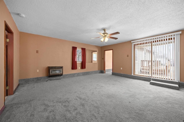 unfurnished living room featuring a textured ceiling, carpet floors, a ceiling fan, and heating unit