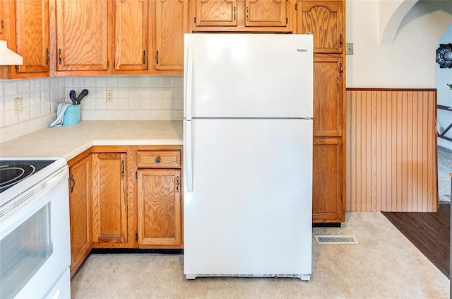 kitchen featuring white appliances, visible vents, decorative backsplash, light countertops, and premium range hood