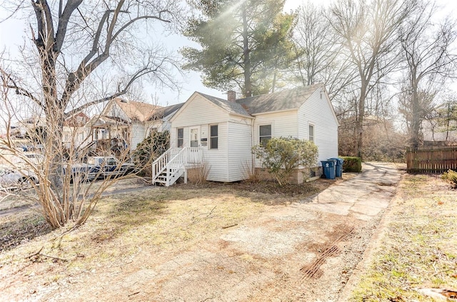 back of property with a chimney