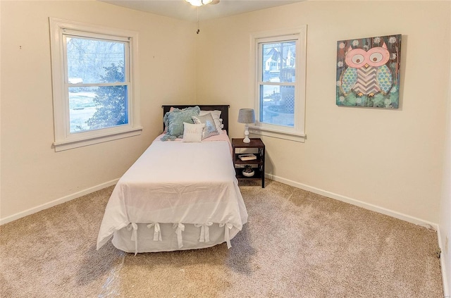 carpeted bedroom with baseboards