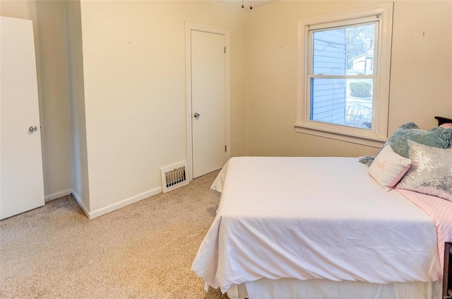 carpeted bedroom with baseboards and visible vents