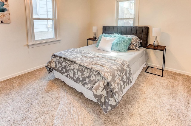 carpeted bedroom featuring baseboards