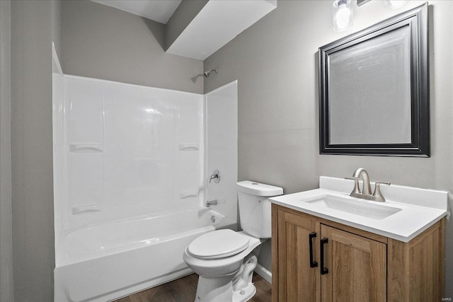 bathroom with tub / shower combination, vanity, toilet, and wood finished floors