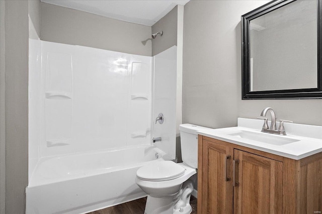 bathroom featuring wood finished floors, vanity, toilet, and shower / bathing tub combination