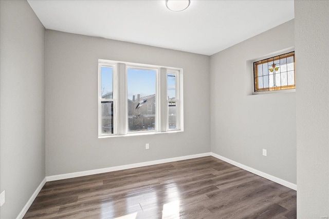 empty room with wood finished floors and baseboards