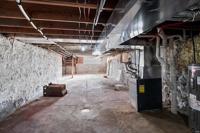 unfinished basement with electric water heater and heating unit