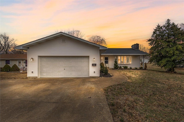 ranch-style house with driveway, a chimney, an attached garage, and a front yard